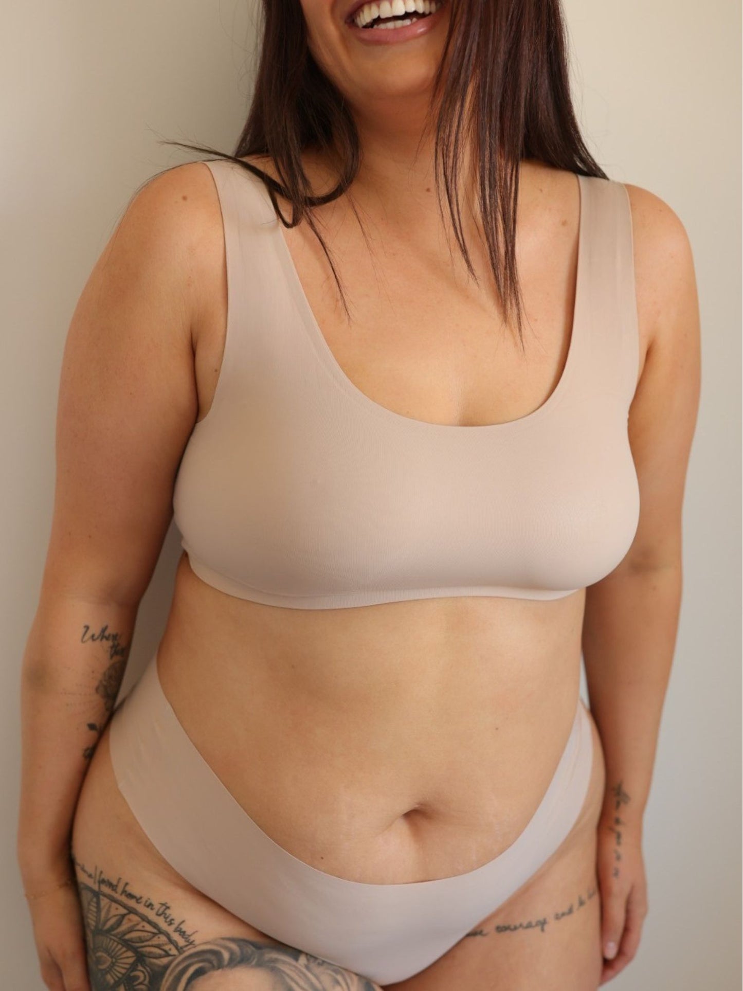 Woman wearing a Cream Tan Comfort Crop and Cream Tan Bikini Thong underwear set against a plain background