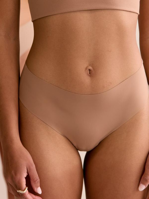 Headless Model Shot  front on wearing seamless Bikini Thong in Macchiato.