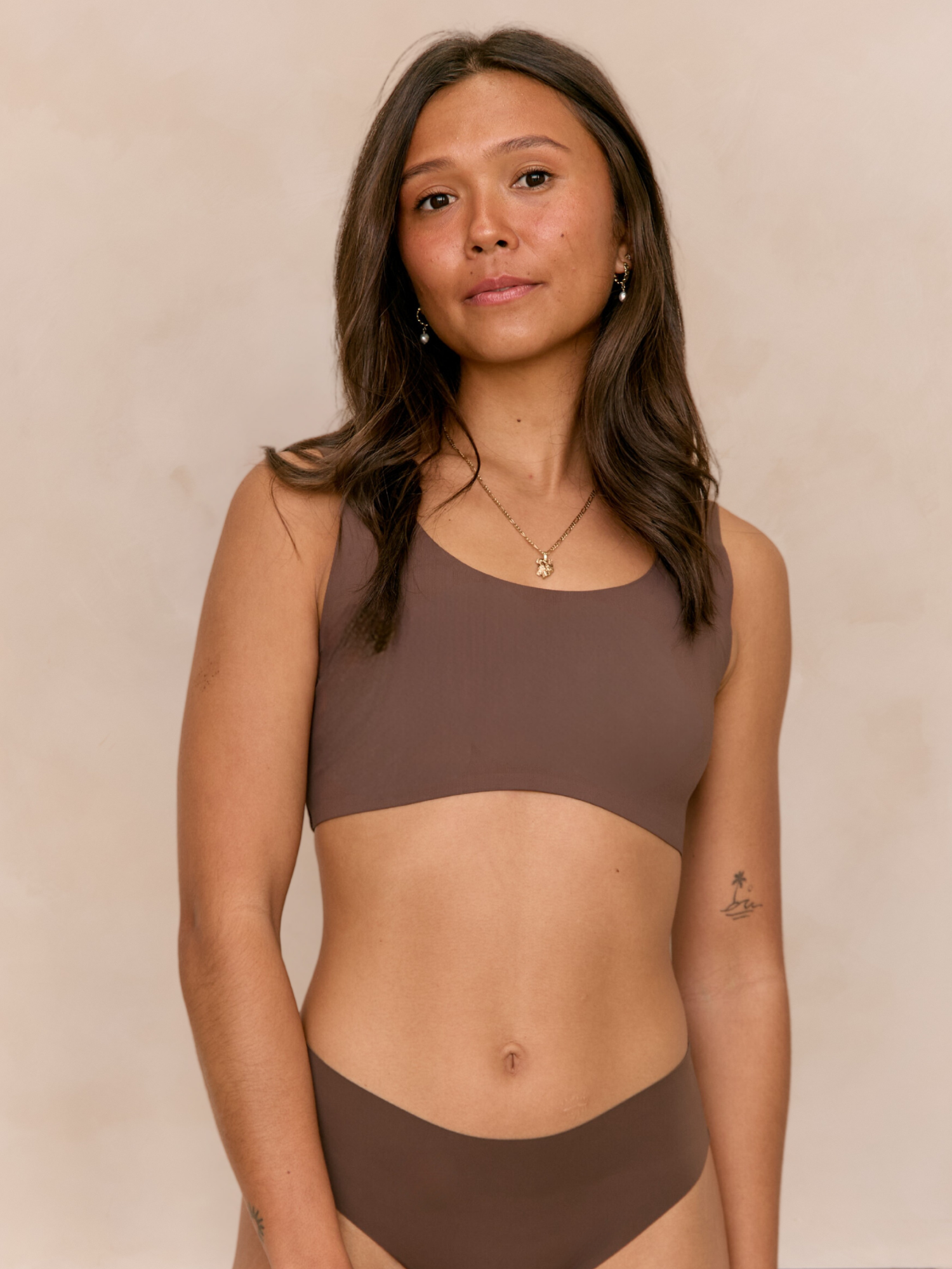 Larni  wearing matching Ola set Seamless Comfort Crop and Bikini Thong in Hot Fudge
