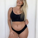 Woman wearing an Ola V crop and Bikini Brief against a white background